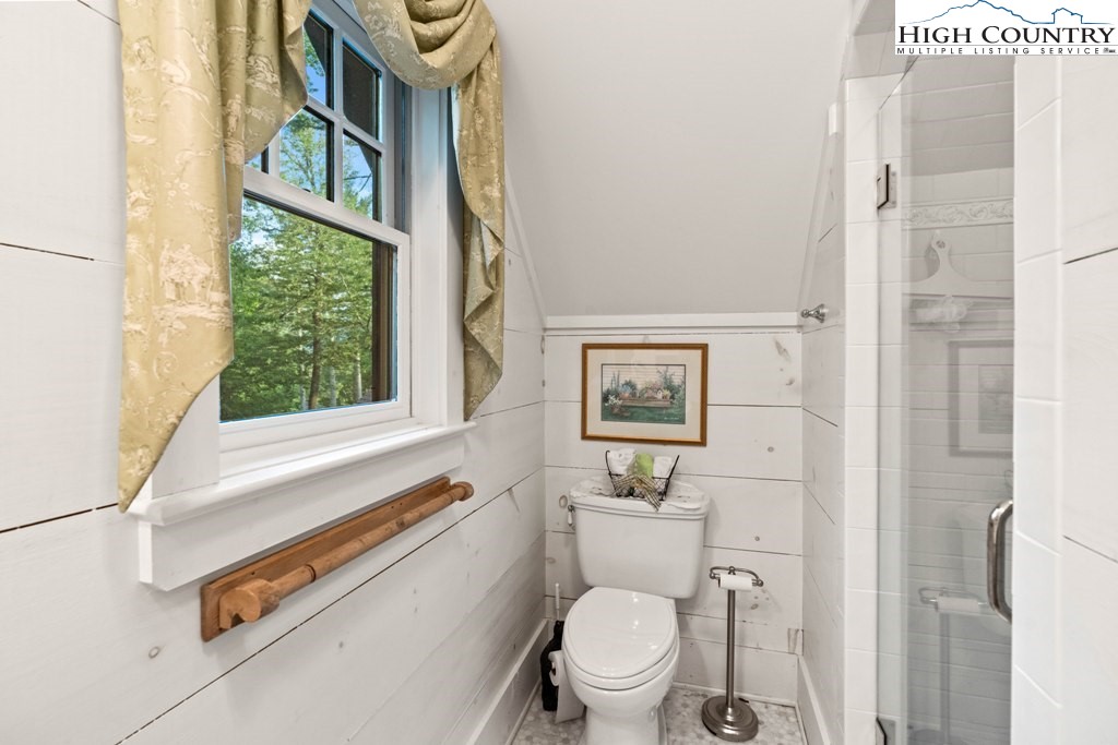 210 Farm Loop Road Banner Elk, NC 28604 - Photo 37 of 48 a bathroom with a toilet a sink and a window