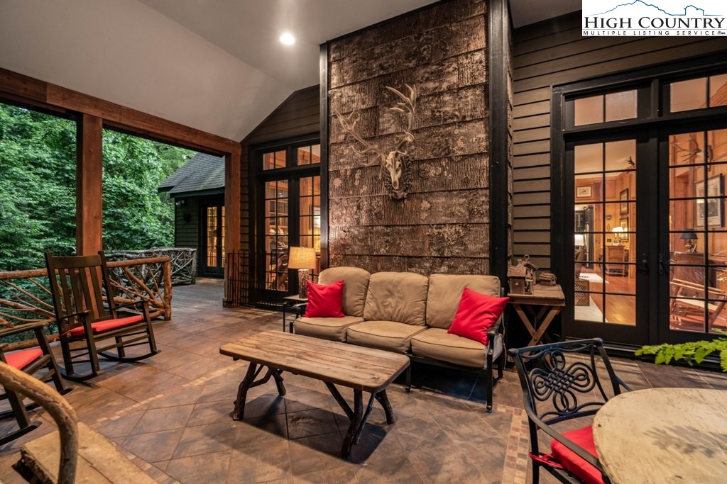 210 Farm Loop Road Banner Elk, NC 28604 - Photo 4 of 48 a living room with furniture and a floor to ceiling window