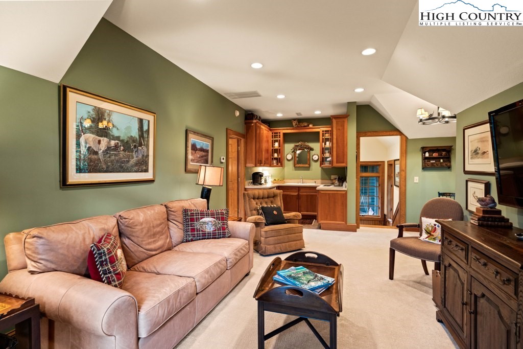 210 Farm Loop Road Banner Elk, NC 28604 - Photo 42 of 48 a living room with furniture kitchen view and a large window