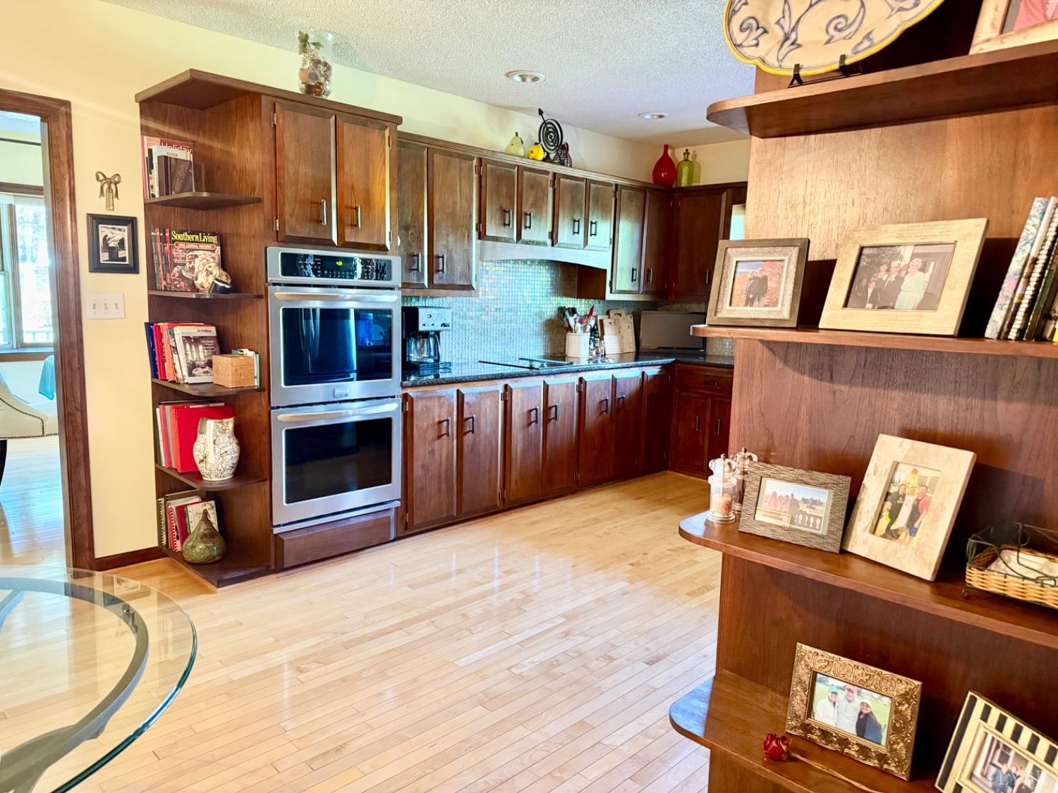 306 Quail Meadows Drive Forest, VA 24551 - Photo 13 of 57 a view of kitchen with stainless steel appliances wooden floor and living room view