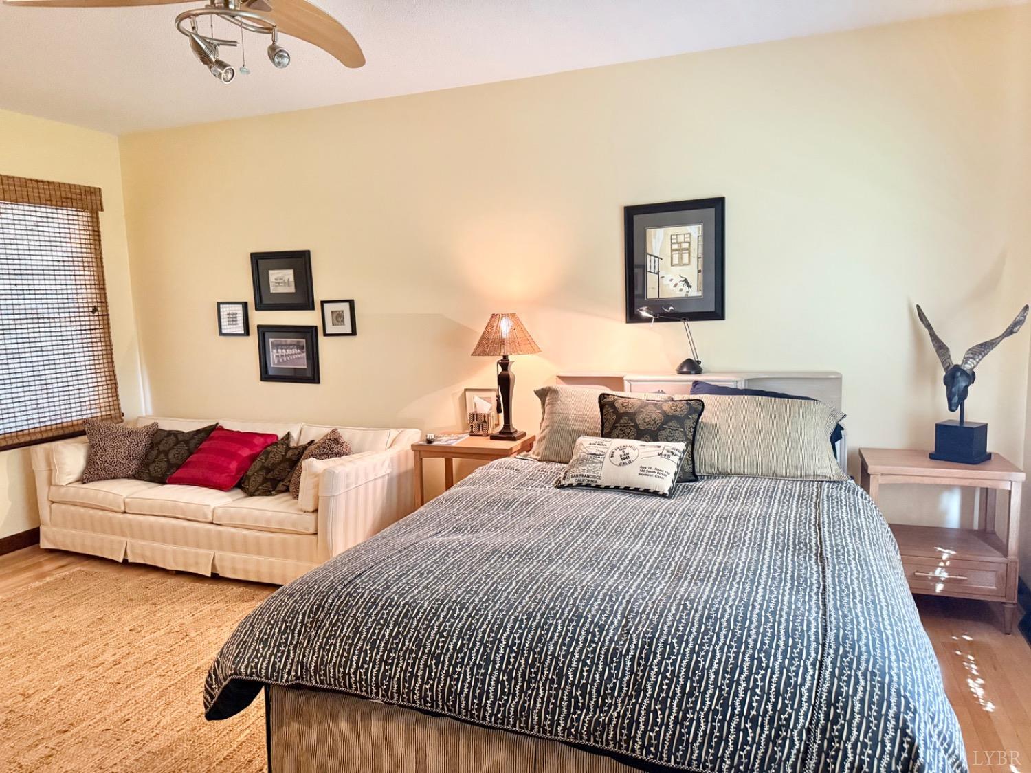 306 Quail Meadows Drive Forest, VA 24551 - Photo 27 of 57 a bedroom with bed and a couch