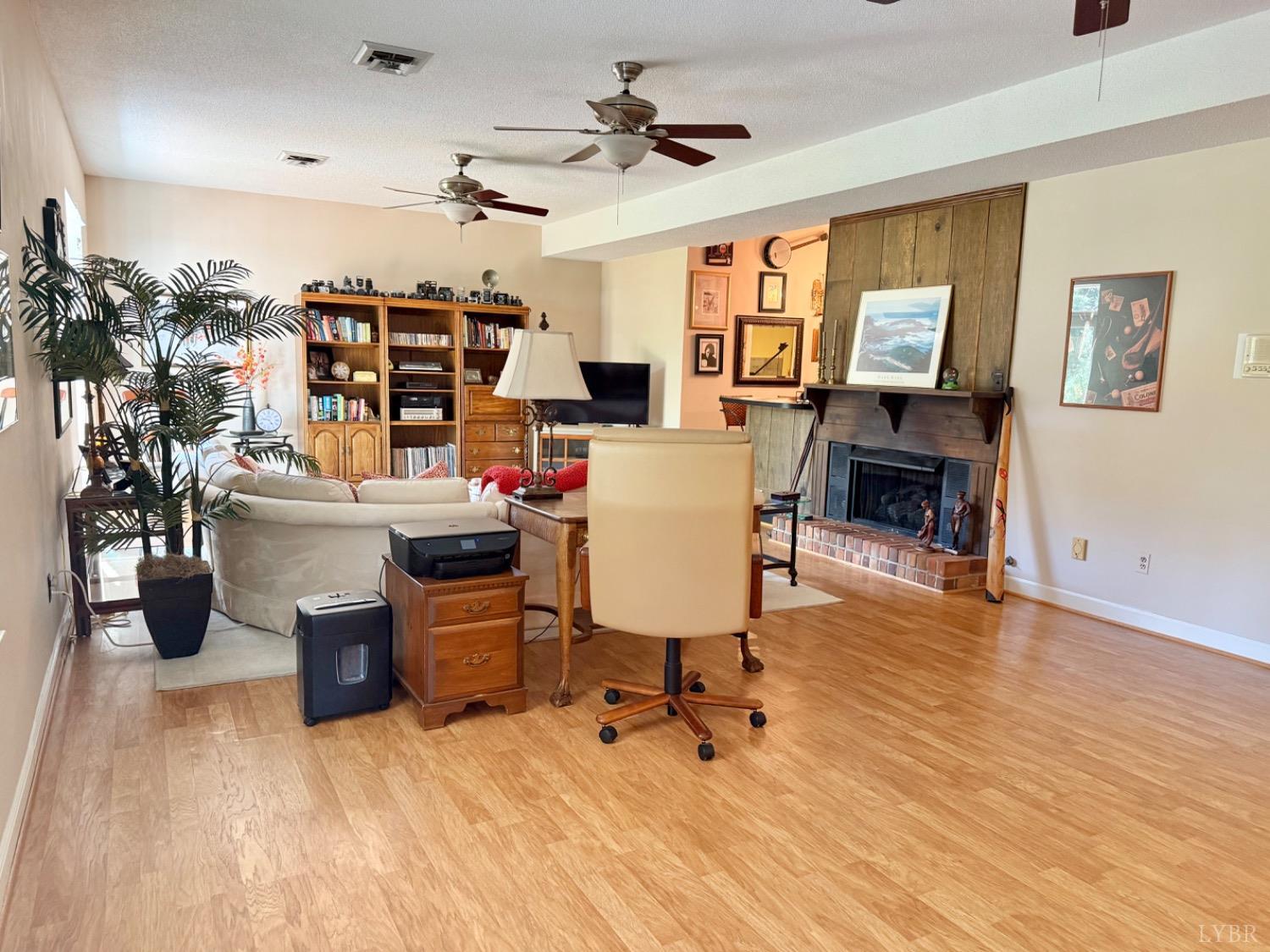 306 Quail Meadows Drive Forest, VA 24551 - Photo 33 of 57 a room with fireplace furniture and a chandelier