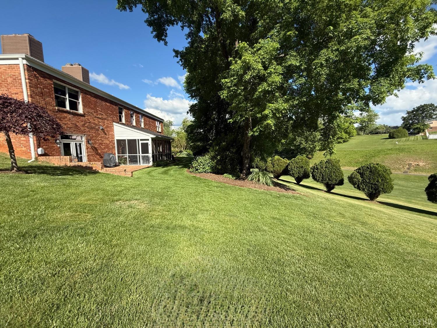 306 Quail Meadows Drive Forest, VA 24551 - Photo 43 of 57 a view of a house with a big yard and large trees