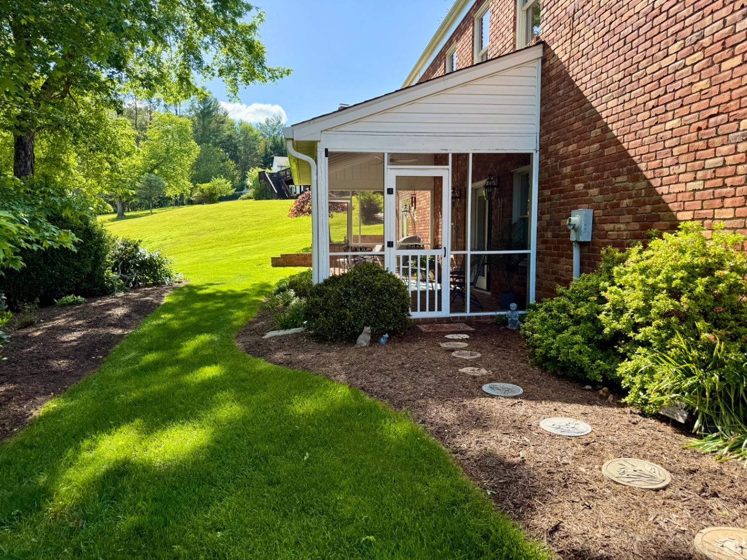 306 Quail Meadows Drive Forest, VA 24551 - Photo 47 of 57 a view of a backyard with plants and large tree
