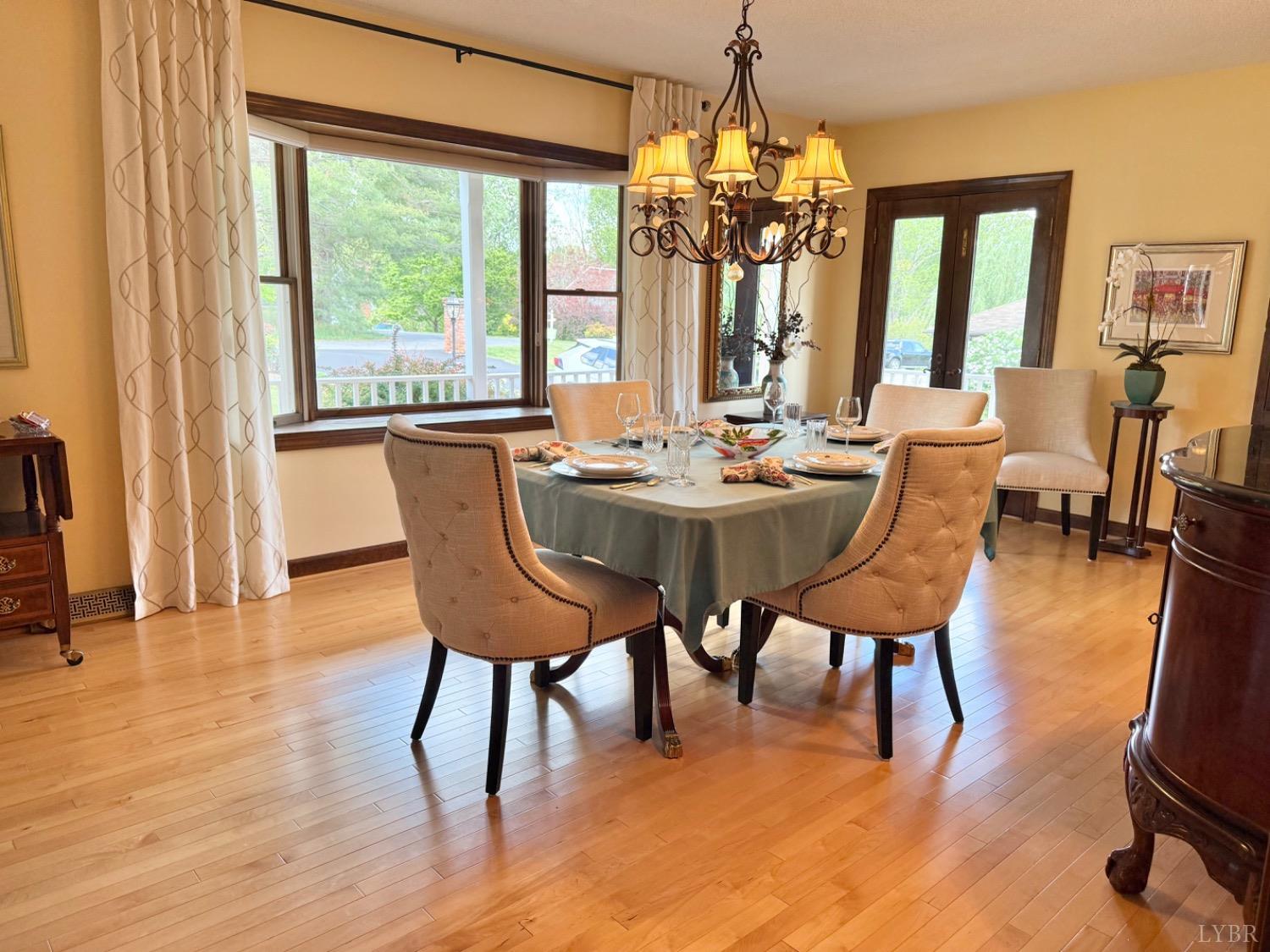 306 Quail Meadows Drive Forest, VA 24551 - Photo 8 of 57 a dining room with furniture a chandelier and wooden floor