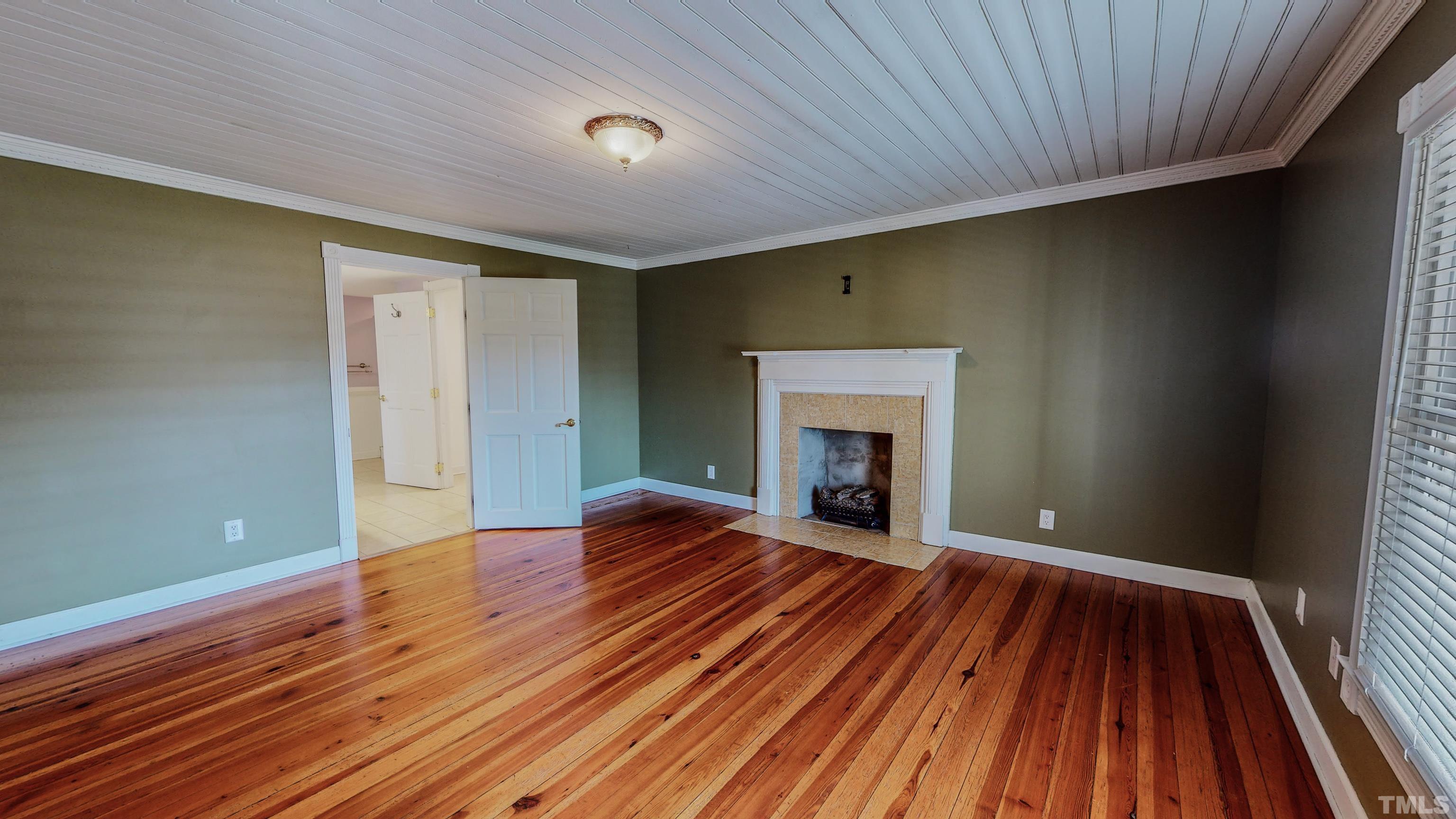 7435 Helena Moriah Road Rougemont, NC 27572 - Photo 27 of 58 a view of an empty room with wooden floor and a window