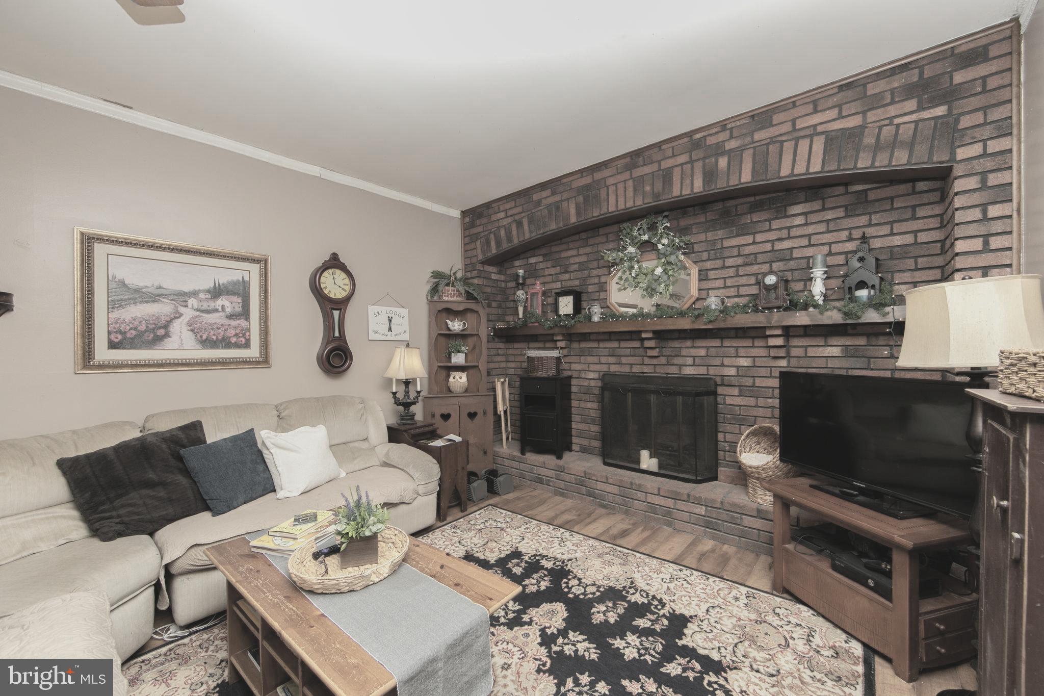 454 Pricketts Mill Road Tabernacle, NJ 08088 - Photo 11 of 49 a living room with furniture a fireplace and a flat screen tv