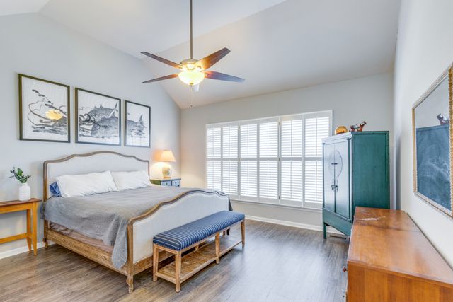 a bedroom with a bed and a large window