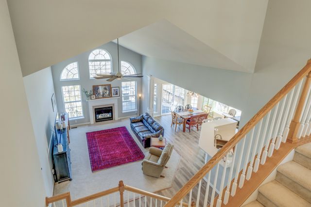 a view of a livingroom with furniture hardwood floor and windows