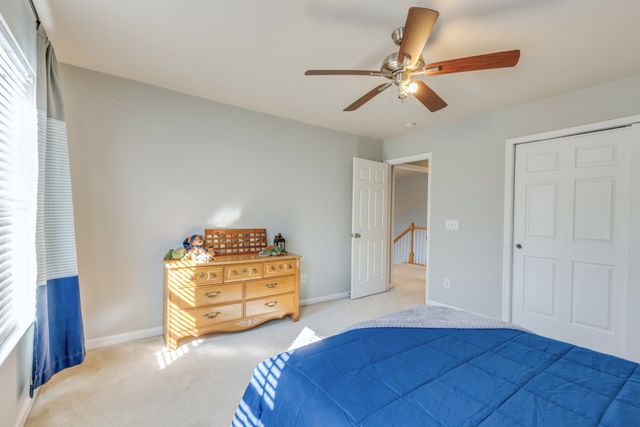 a bathroom with a granite countertop sink a toilet and a mirror