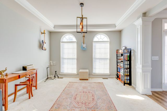 a view of a livingroom with a window and a chandelier