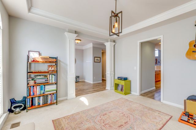 a view of a bedroom with workspace and wooden floor