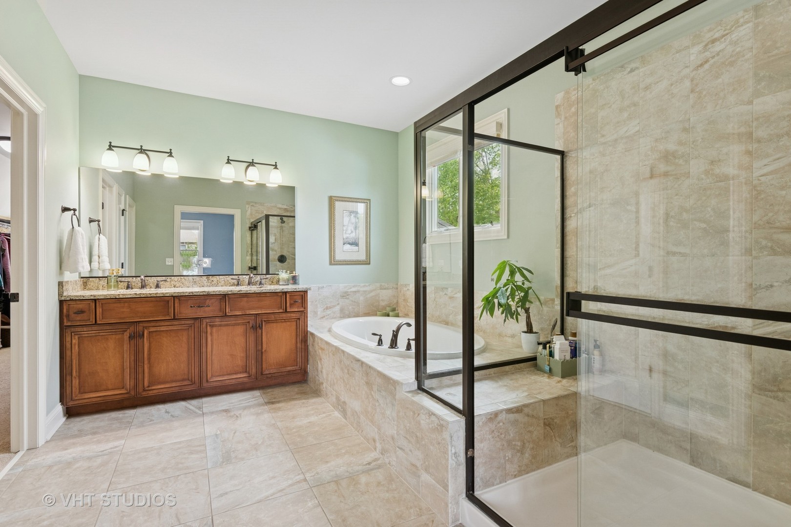 76 Landon Circle Wheaton, IL 60189 - Photo 24 of 51 a spacious bathroom with a granite countertop tub shower and mirror