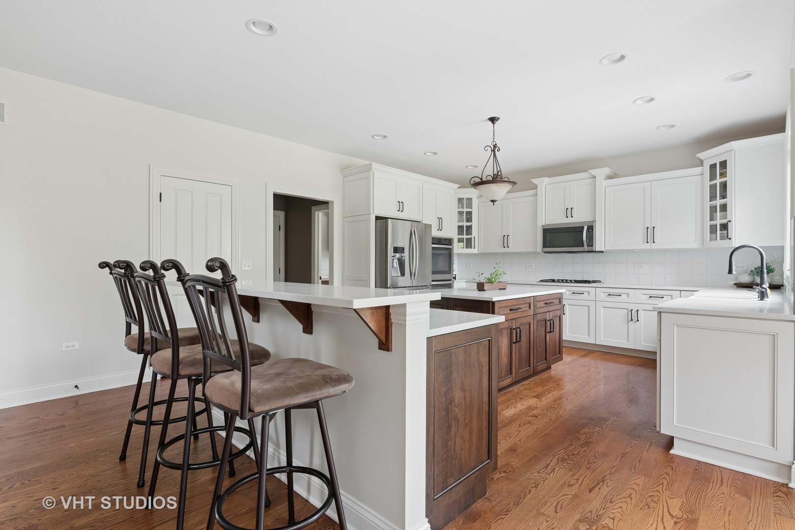 76 Landon Circle Wheaton, IL 60189 - Photo 8 of 51 a kitchen with stainless steel appliances granite countertop a stove top oven a sink dishwasher and a refrigerator with wooden floor