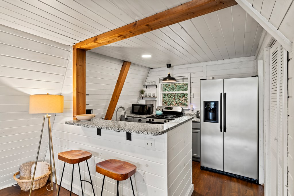 115 Barnhill Road Blairsville, GA 30512 - Photo 22 of 65 a kitchen with stainless steel appliances granite countertop a sink and a refrigerator