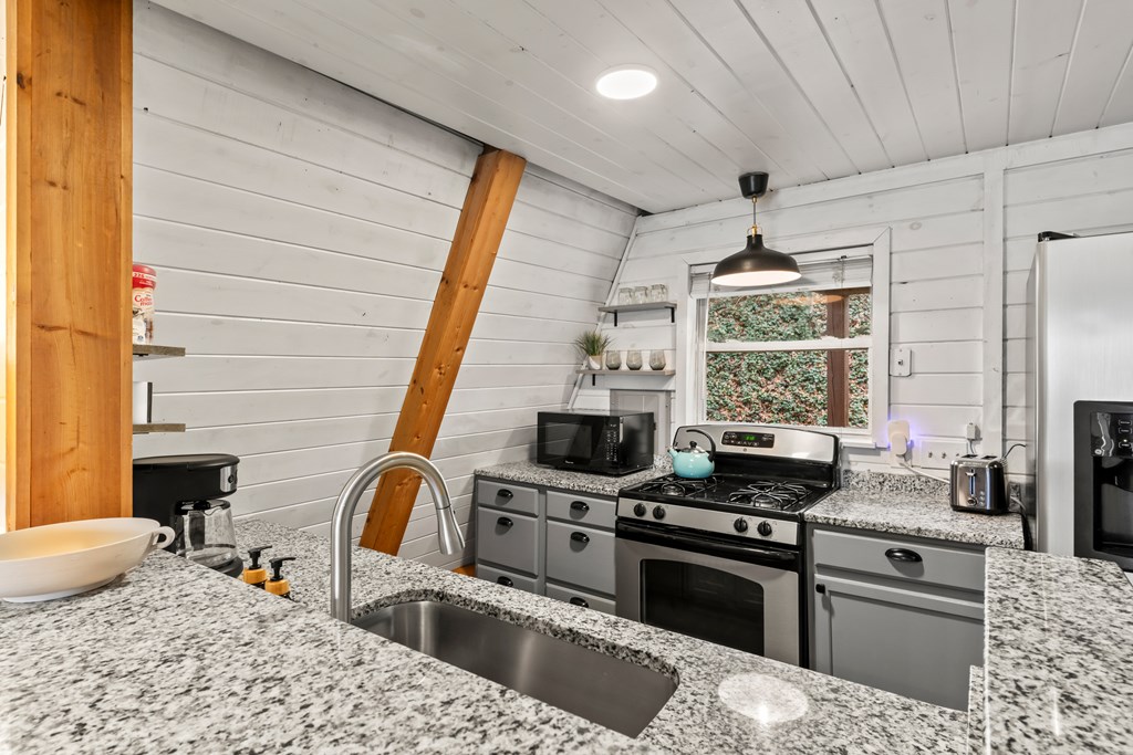 115 Barnhill Road Blairsville, GA 30512 - Photo 23 of 65 a kitchen with a stove a sink and a refrigerator