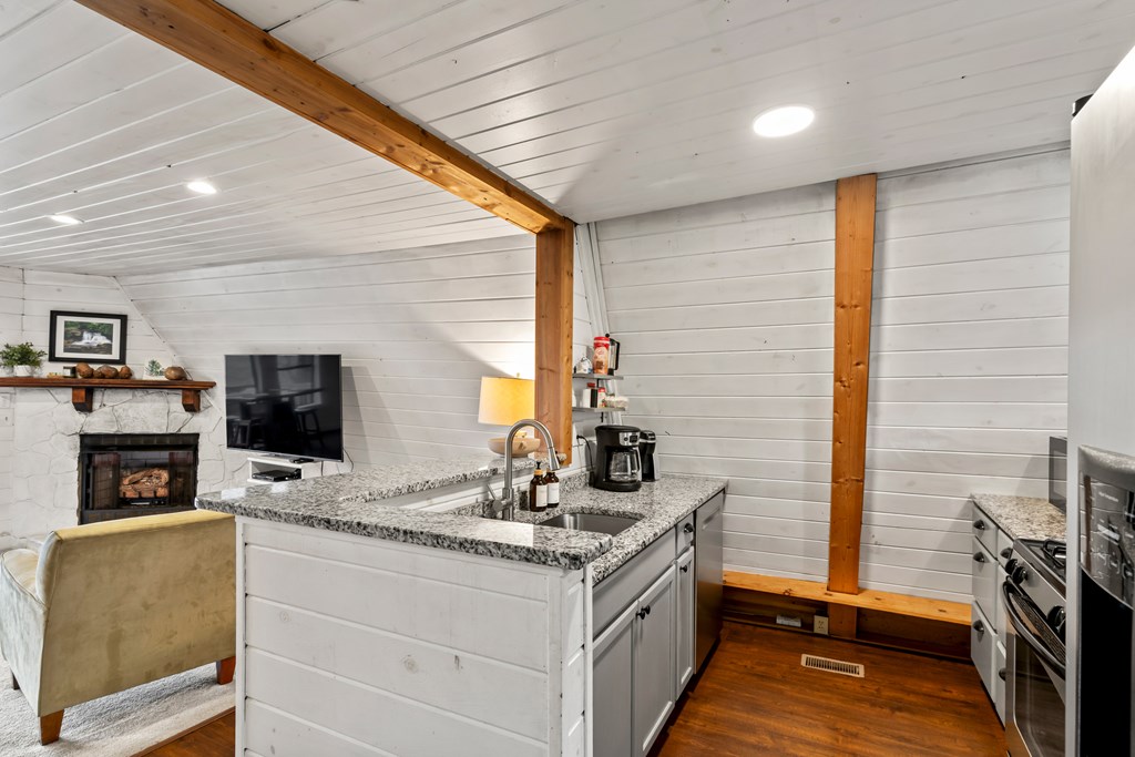 115 Barnhill Road Blairsville, GA 30512 - Photo 25 of 65 a kitchen with stainless steel appliances granite countertop a stove and a refrigerator