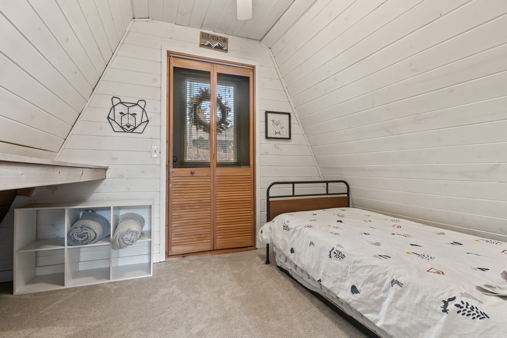 115 Barnhill Road Blairsville, GA 30512 - Photo 31 of 65 a bedroom with a bed and a wall painting