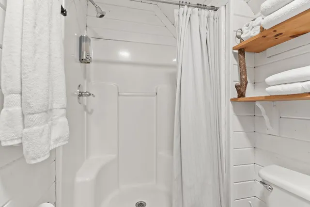a view of a balcony with chairs and wooden floor