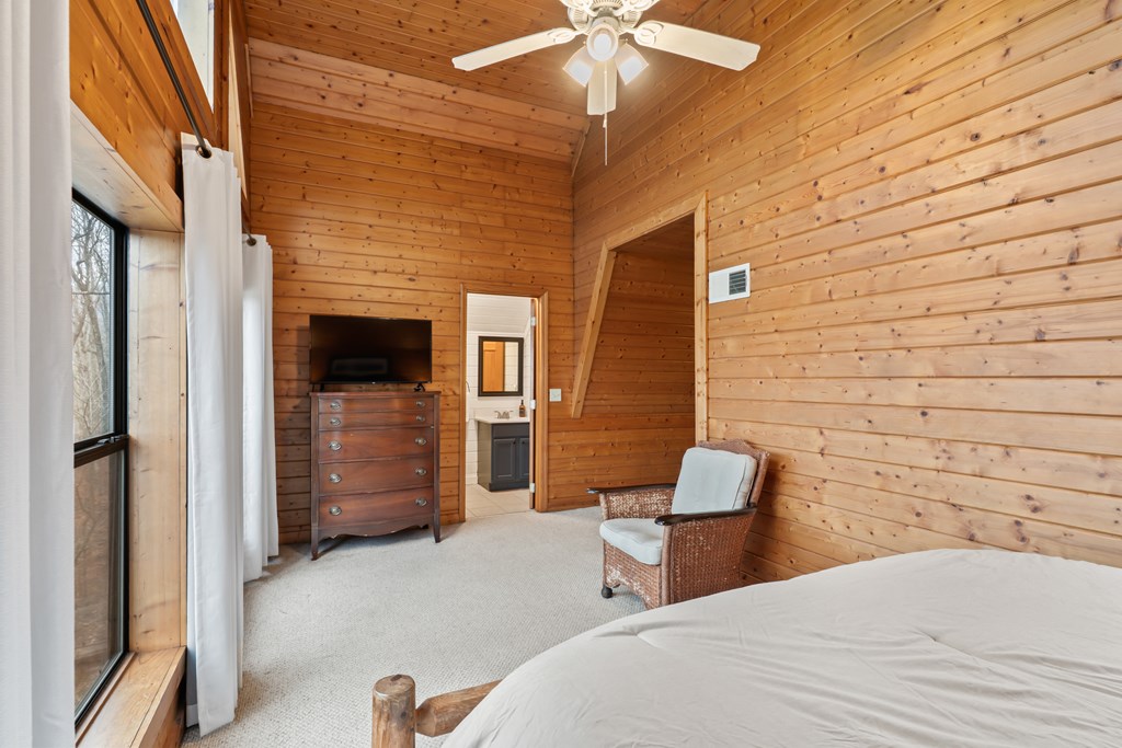 115 Barnhill Road Blairsville, GA 30512 - Photo 39 of 65 a bedroom with a bed and a chair