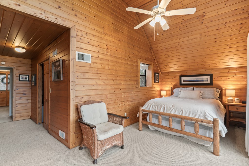 115 Barnhill Road Blairsville, GA 30512 - Photo 40 of 65 a bedroom with a bed and a chandelier