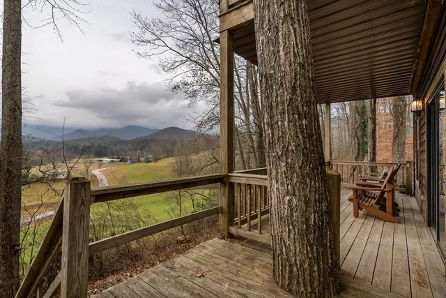 a view of a wooden house with large trees