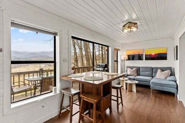 a view of a balcony with mountain view and wooden floor