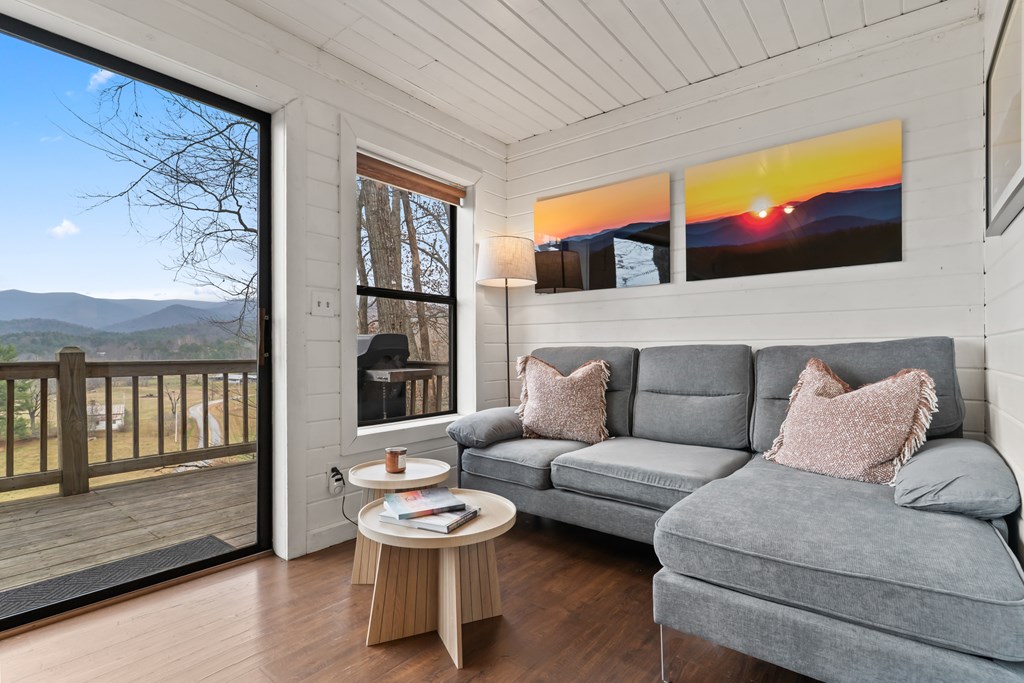 115 Barnhill Road Blairsville, GA 30512 - Photo 7 of 65 a living room with furniture and a floor to ceiling window next to a large window