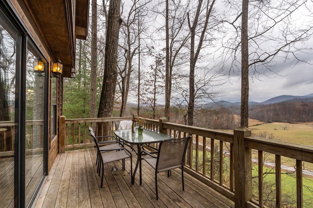 115 Barnhill Road Blairsville, GA 30512 - Photo 8 of 65 a view of a balcony with mountain view and wooden floor