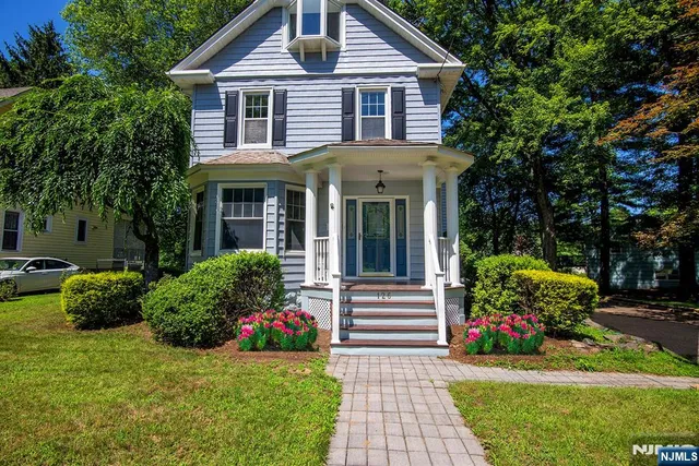 a front view of a house with a garden and plants