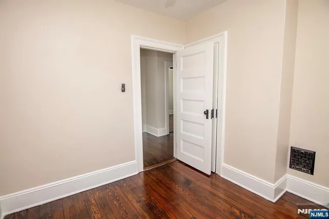 an empty room with wooden floor