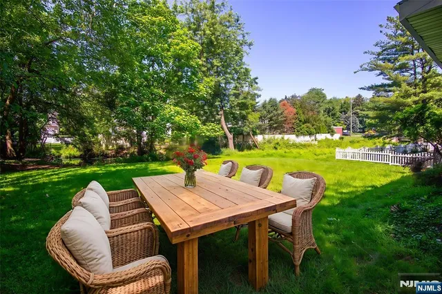 a view of a patio with swimming pool and yard