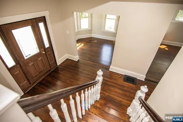 a view of an entryway with wooden floor