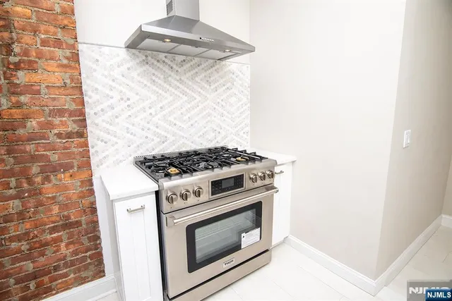 a white stove top oven sitting inside of a kitchen