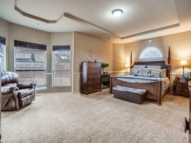 a bedroom with furniture and a window