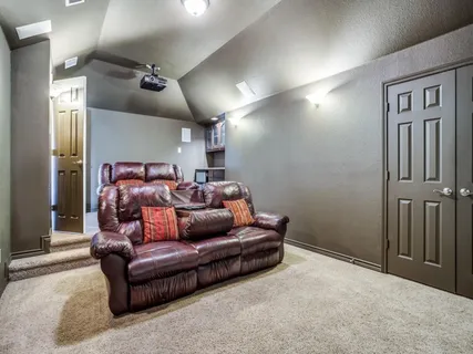 a living room with furniture a large window and a flat screen tv