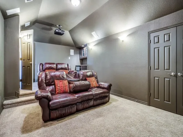 a living room with furniture a large window and a flat screen tv