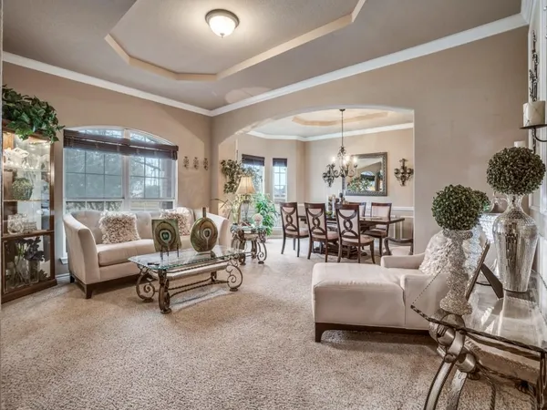 a living room with furniture and a chandelier