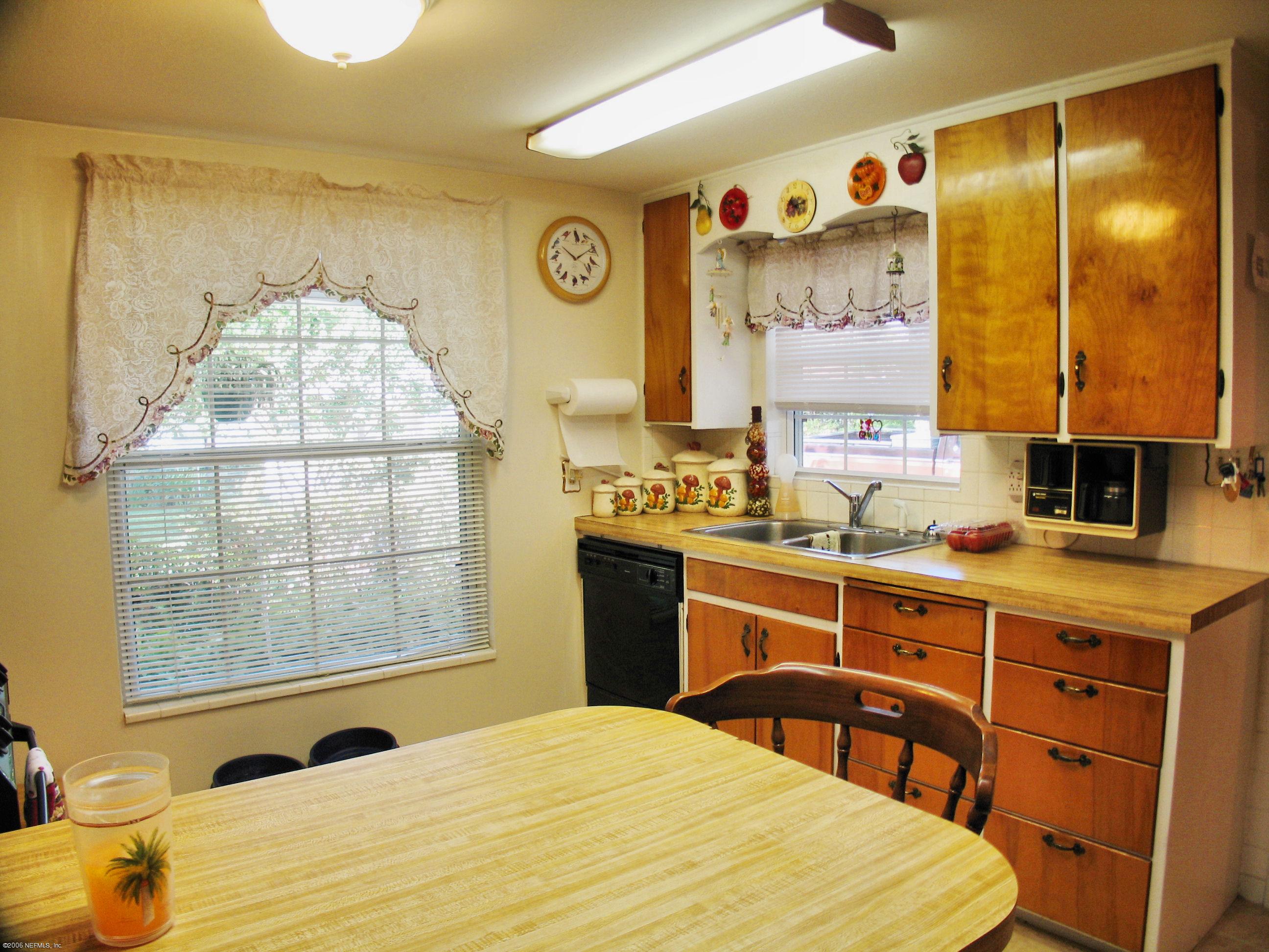 2945 Holly Road Orange Park, FL 32065 - Photo 4 of 5 a bedroom with a bed and a table