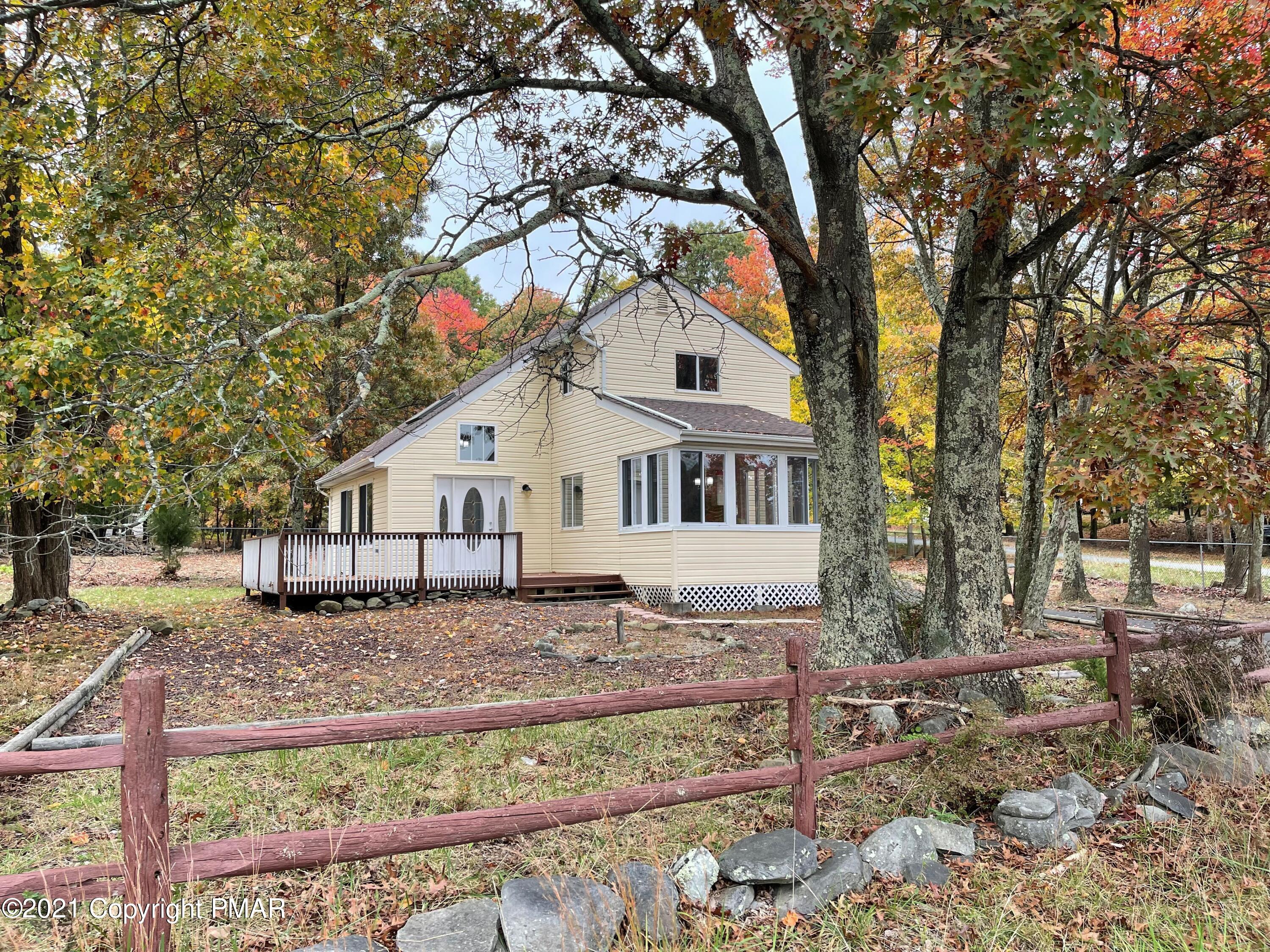 2115 Bushkill Circle Bushkill, PA 18324 - Photo 1 of 42 a white house that has a tree in front of it