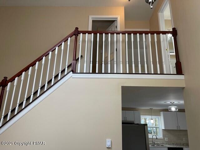 2115 Bushkill Circle Bushkill, PA 18324 - Photo 19 of 42 a view of a hallway with wooden floor and staircase