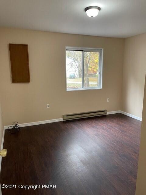 2115 Bushkill Circle Bushkill, PA 18324 - Photo 23 of 42 an empty room with wooden floor and windows