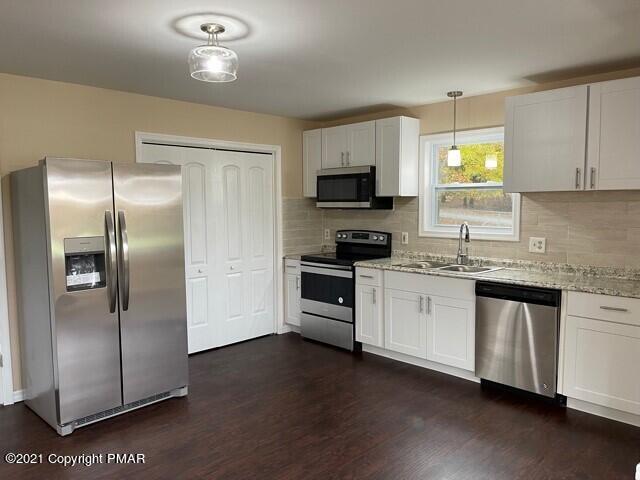 2115 Bushkill Circle Bushkill, PA 18324 - Photo 8 of 42 a kitchen with a refrigerator and a stove top oven