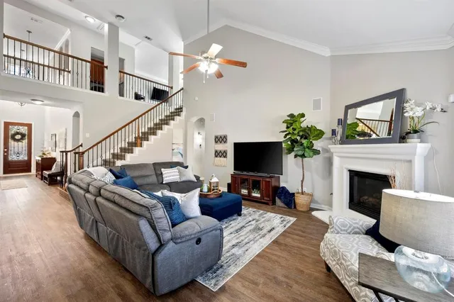 a living room with furniture a fireplace and a flat screen tv