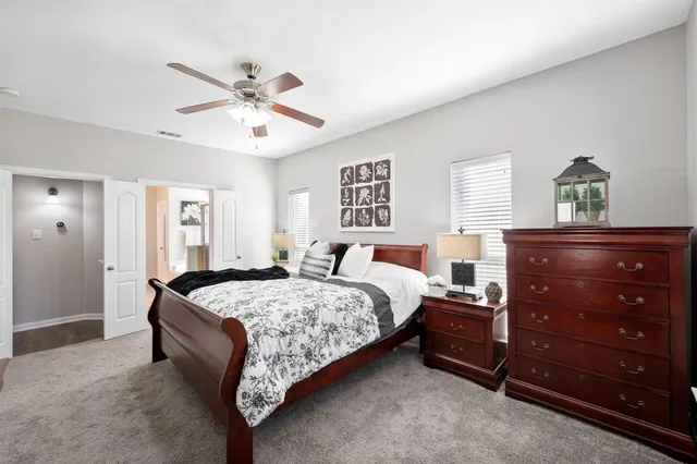 a bedroom with a bed and a dresser