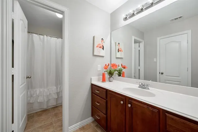 a bathroom with a sink vanity and a mirror