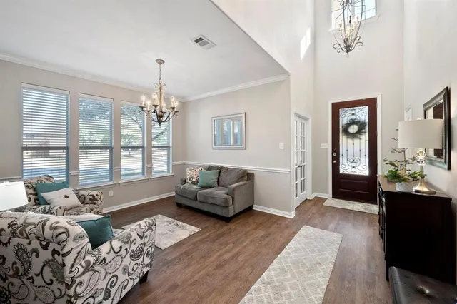 a living room with furniture and a chandelier