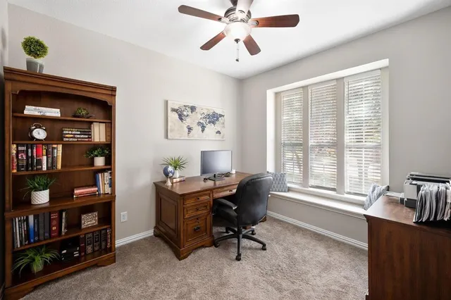 a view of a workspace with a window and cabinet