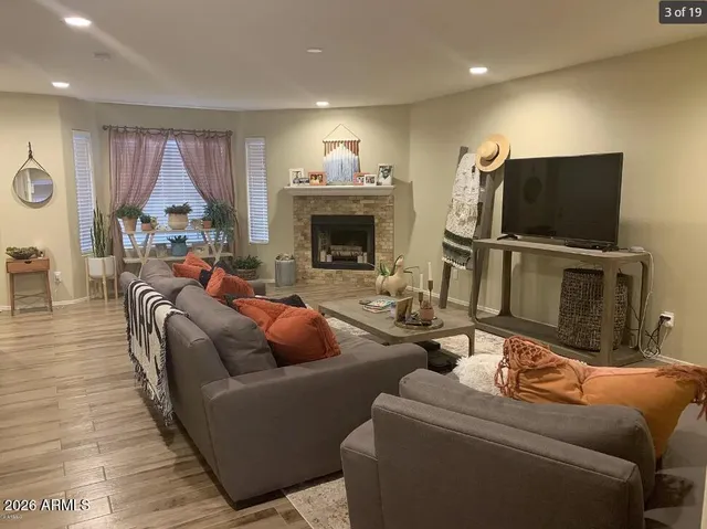 a living room with furniture a fireplace and a flat screen tv