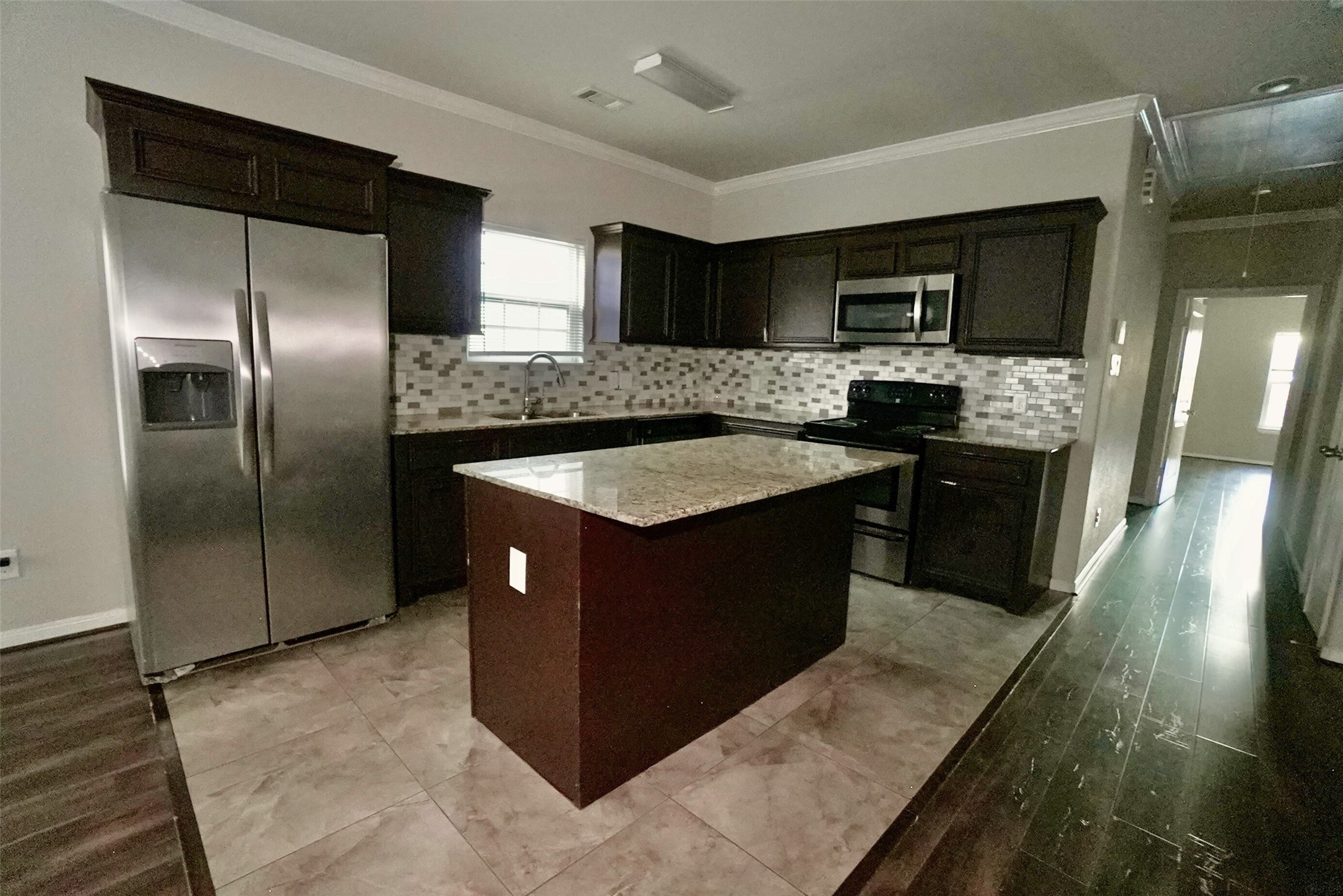 2523 Kirk Street, Unit B Houston, TX 77026 - Photo 4 of 16 a kitchen with stainless steel appliances granite countertop a stove a sink and a refrigerator